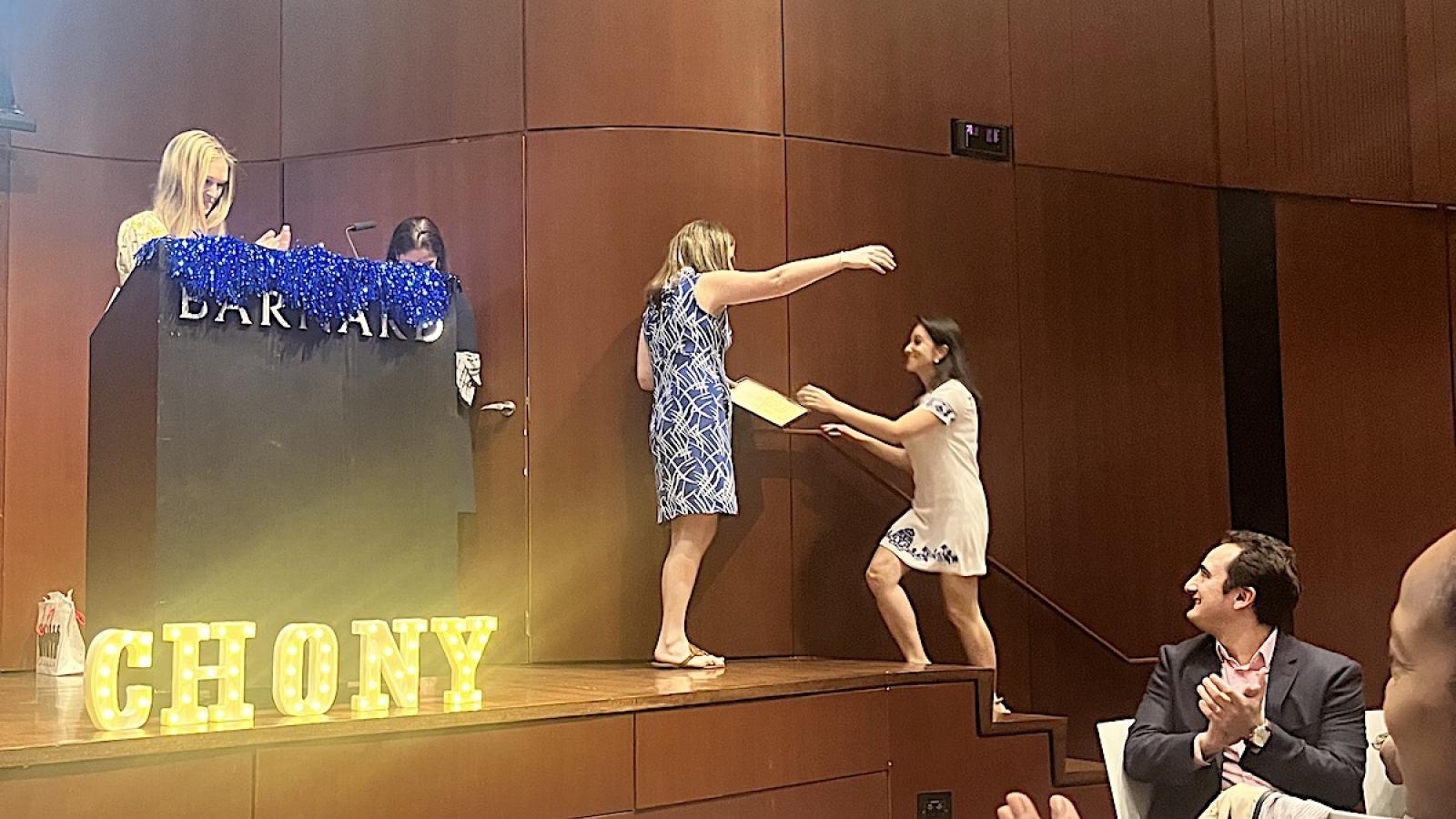 person getting diploma on stage