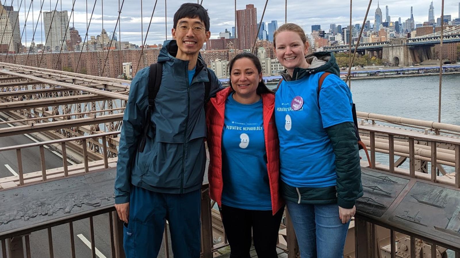 Nephrology fellows smiling together on a bridge.