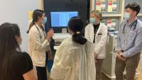 group of doctors looking at a computer