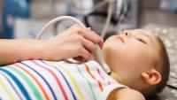 Little boy undergoing thyroid ultrasound examination.