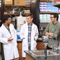 Researchers speaking in a lab.