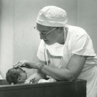 Black and white photo of Dr. Wolff with a child.